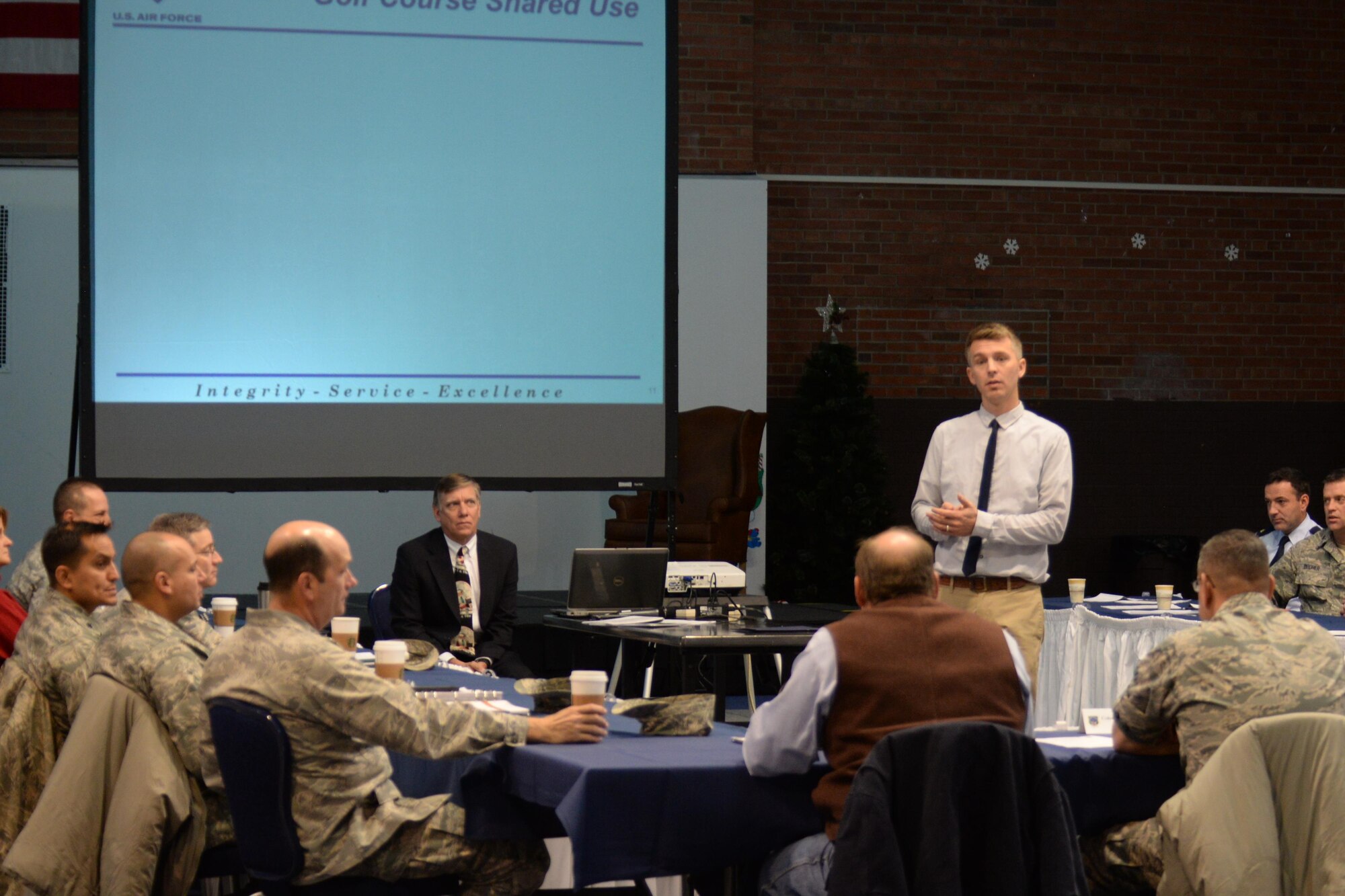 Gabriel Laramie, 90th Force Support Squadron, speaks at an Air Force Community Partnership Program meeting in the Fall Hall Community Center on F.E. Warren Air Force Base, Wyo., Dec. 15, 2015. He discussed an agreement between the F.E. Warren Golf Course and Cheyenne, Wyo., Golf Courses to allow annual pass holders of the base course to have three free golf round vouchers to Cheyenne courses and vice versa. (U.S. Air Force photo by Senior Airman Jason Wiese/Released)