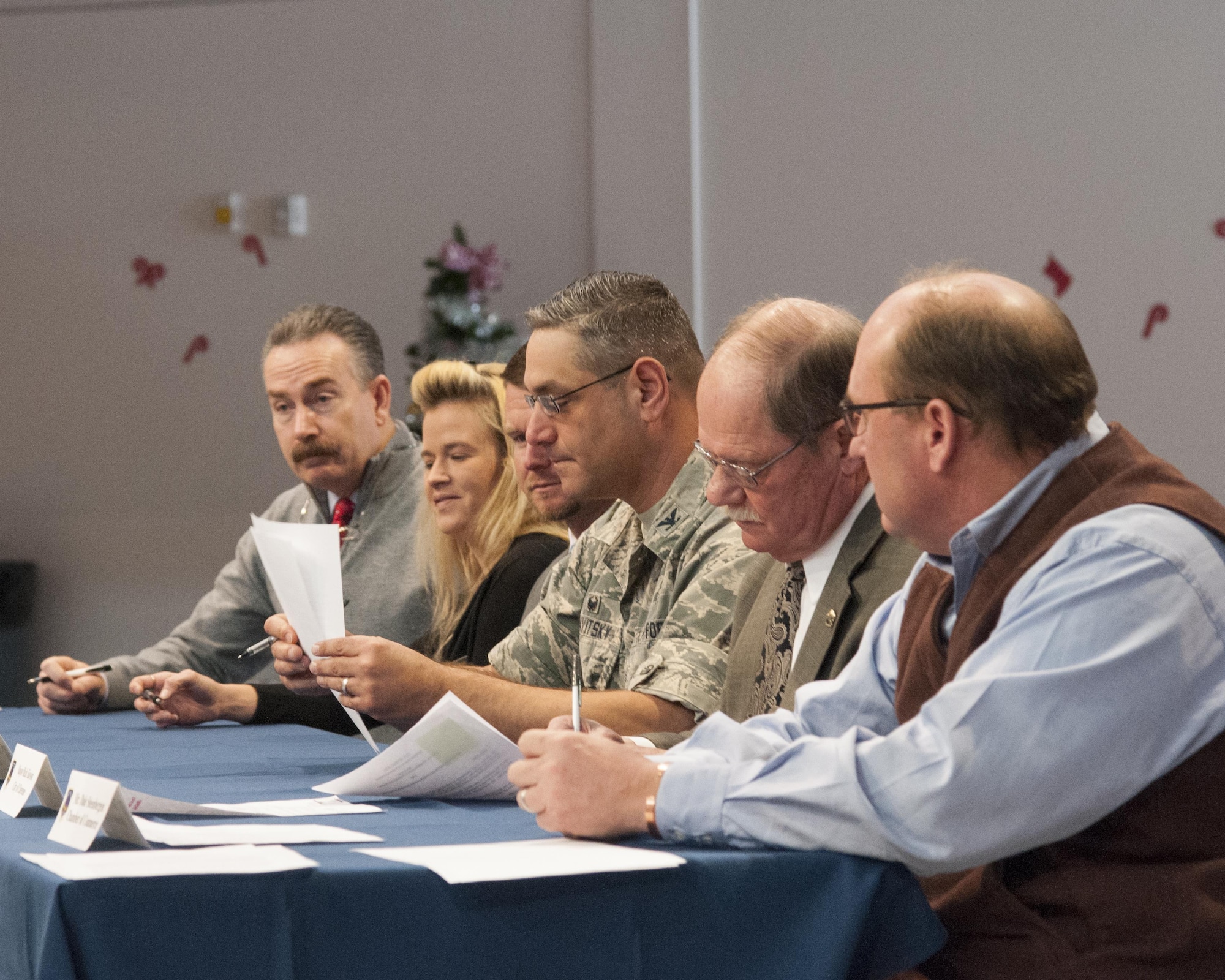 Colonel Stephen Kravitsky , 90th Missile Wing commander; Cheyenne, Wyo., Mayor Rick Kaysen (second from the right); and other members of the F.E. Warren Community Partnership Leadership Committee sign several documents during an Air Force Community Partnership signing event in the Fall Hall Community Center on F.E. Warren Air Force Base, Wyo., Dec. 15, 2015. The committee signed five documents, and more base-community partnership arrangements are in the works. (U.S. Air Force photo by Senior Airman Jason Wiese/Released)