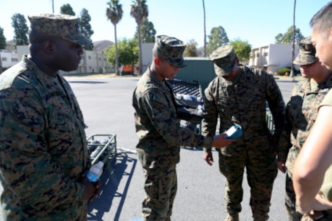 Sailors from 1st Medical Battalion, 1st Marine Logistics Group and various other units learn about a handheld water testing system used by water purification specialists to keep Marines and Sailors healthy, aboard Camp Pendleton, Calif., Nov. 19, 2015. Med. Bn. hosted a three-day training evolution with units across the western region to increase their readiness and proficiency in preventive medicine.