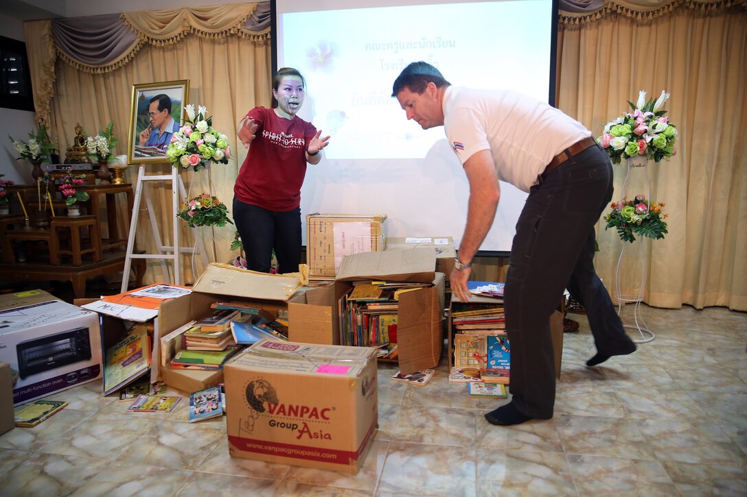 U.S. Navy Chaplain (Lt. Cmdr.) Glen D. Kitzman arranges books during a recent community outreach event at a local school in Chanthaburi, Thailand, Dec. 21, 2015. Military Sealift Command Far East along with partners in Singapore donated more than 1,200 English books to the Pong Nam Ron, Pliu and Ban Trok Nong elementary schools. U.S. Navy photo by Grady T. Fontana
