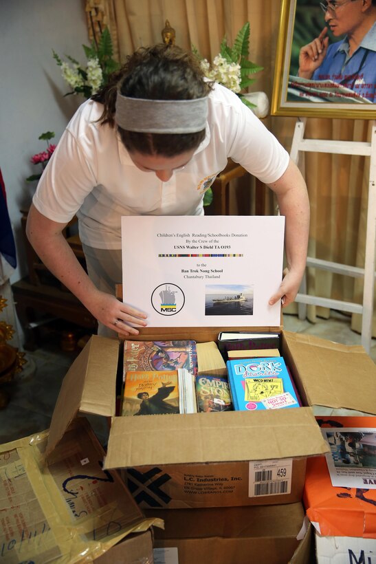 Keystone Club volunteer Rachel Kitzman unpacks donated English books during a recent community outreach event at a local school in Chanthaburi, Thailand, Dec. 21, 2015. Keystone Club is a Boys & Girls Clubs of America program in which youth participate in activities in three focus areas: academic success, career preparation and community service. U.S. Navy photo by Grady T. Fontana