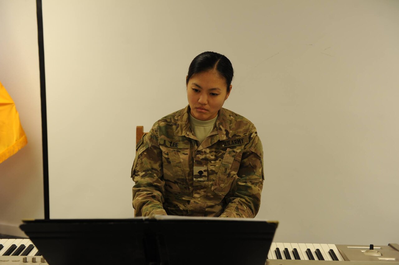 Army Spc. Anne Lee plays the piano during an event on Bagram Airfield in Afghanistan. Courtesy photo by Kevin Walston