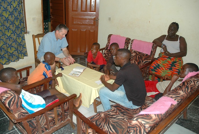 Ken Beutel reads to children at a center in Bo, Sierra Leone, where he and his wife Deb volunteer their time and professional skills to help children and families. Ken, deputy program manager for Information Systems and Infrastructure at MCSC, used his information technology expertise to establish a classroom and provide online learning capabilities for the children in Bo. (Courtesy photo)