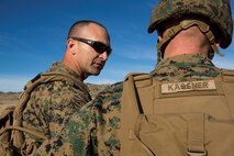 U.S. Marine Corps Capt. Brandon Currie, left, a company commander with 2nd Battalion, 4th Marine Regiment, 1st Marine Division briefs Col. Kenneth Kassner, right, the commanding officer of 5th Marine Regiment, during Steel Knight 2016 at Marine Corps Air-Ground Combat Center, Twentynine Palms, Calif., Dec. 10, 2015. Steel Knight is an annual field training exercise that enables 1st Marine Division to test and refine its command and control capabilities by acting as the headquarters element for a forward-deployed Marine Expeditionary Force. (U.S. Marine Corps Combat Camera photograph by ( Lance Cpl. Roderick L. Jacquote)/RELEASED)