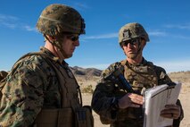 U.S. Marine Corps Capt. Nicholas Allen, right, a company commander with 2nd Battalion, 4th Marine Regiment, 1st Marine Division, briefs Col. Kenneth Kassner, left, the commanding officer of 5th Marine Regiment, during Steel Knight 2016 at Marine Corps Air-Ground Combat Center, Twentynine Palms, Calif., Dec. 10, 2015. Steel Knight is an annual field training exercise that enables 1st Marine Division to test and refine its command and control capabilities by acting as the headquarters element for a forward-deployed Marine Expeditionary Force. (U.S. Marine Corps Combat Camera photograph by ( Lance Cpl. Roderick L. Jacquote)/RELEASED)