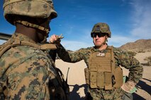 U.S. Marine Corps Cpl. Abiel Tekie, left, a squad leader with 2nd Battalion, 4th Marine Regiment, 1st Marine Division briefs Col. Kenneth Kassner, right, the commanding officer of 5th Marine Regiment, during Steel Knight 16 at Marine Corps Air-Ground Combat Center, Twentynine Palms, Calif., Dec. 10, 2015. Steel Knight enables 1st Marine Division to test and refine its command and control capabilities by acting as the headquarters element for a forward-deployed Marine Expeditionary Force. (U.S. Marine Corps Combat Camera photograph by ( Lance Cpl. Roderick L. Jacquote)/RELEASED)