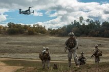 U.S. Marines with Fox Company, 2nd Battalion, 7th Marine Regiment, 1st Marine Division await aircraft extraction via MV-22B Osprey to land during a tactical recovery aircraft personnel exercise as a part of Steel Knight 16 at Fort Hunter Liggett, Calif., Dec. 11, 2015. Steel Knight is an annual field training exercise that enables 1st Marine Division to test and refine its command and control capabilities by acting as the headquarters element for a forward-deployed Marine Expeditionary Force. (U.S. Marine Corps Combat Camera photograph by ( Lance Cpl. Roderick L. Jacquote)/RELEASED)