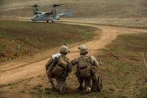 U.S. Marines with Fox Company, 2nd Battalion, 7th Marine Regiment, 1st Marine Division await aircraft extraction via MV-22B Osprey to land during a tactical recovery aircraft personnel exercise as a part of Steel Knight 2016 at Fort Hunter Liggett, Calif., Dec. 11, 2015. Steel Knight is an annual field training exercise that enables 1st Marine Division to test and refine its command and control capabilities by acting as the headquarters element for a forward-deployed Marine Expeditionary Force. (U.S. Marine Corps Combat Camera photograph by ( Lance Cpl. Roderick L. Jacquote)/RELEASED)