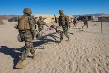 U.S. Marines and Sailors with Headquarters Company, 5th Marine Regiment, 1st Marine Division transport a simulated casualty as a part of a tactical recovery aircraft personnel mission in support of Steel Knight 2016 at Marine Corps Air-Ground Combat Center, Twentynine Palms, Calif., Dec. 12, 2015. Steel Knight is an annual field training exercise that enables 1st Marine Division to test and refine its command and control capabilities by acting as the headquarters element for a forward-deployed Marine Expeditionary Force. (U.S. Marine Corps Combat Camera photograph by ( Lance Cpl. Roderick L. Jacquote)/RELEASED)