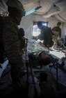 U.S. Marines and Sailors with Headquarters Company, 1st Marine Division, 5th Marine Regiment, aid a simulated casualty as a part of a tactical recovery aircraft personnel mission in support of Steel Knight 2016 at Marine Corps Air-Ground Combat Center, Twentynine Palms, Calif., Dec. 12, 2015. Steel Knight is an annual field training exercise that enables 1st Marine Division to test and refine its command and control capabilities by acting as the headquarters element for a forward-deployed Marine Expeditionary Force. (U.S. Marine Corps Combat Camera photograph by ( Lance Cpl. Roderick L. Jacquote)/RELEASED)