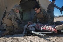 U.S. Marines and Sailors with Headquarters Company, 5th Marine Regiment, 1st Marine Division aid a simulated casualty as a part of a tactical recovery aircraft personnel mission in support of Steel Knight 2016 at Marine Corps Air-Ground Combat Center, Twentynine Palms, Calif., Dec. 12, 2015. Steel Knight is an annual field training exercise that enables 1st Marine Division to test and refine its command and control capabilities by acting as the headquarters element for a forward-deployed Marine Expeditionary Force. (U.S. Marine Corps Combat Camera photograph by ( Lance Cpl. Roderick L. Jacquote)/RELEASED)