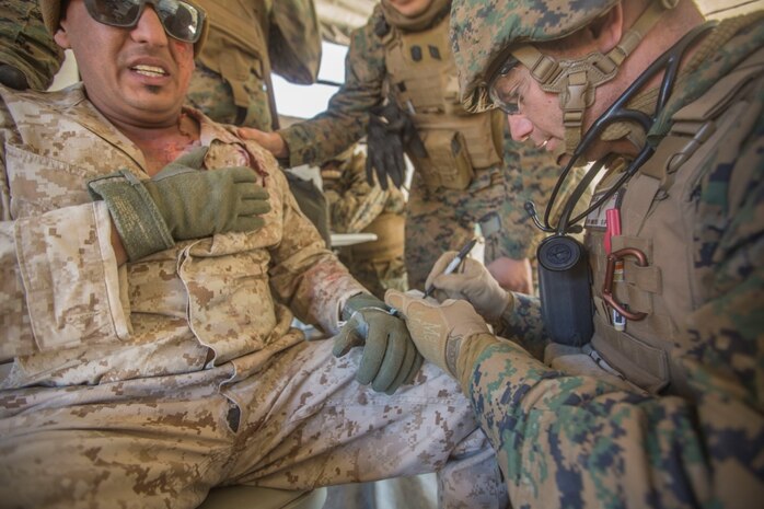U.S. Navy Lt. Christopher Mullin, 5th Marine Regiment surgeon, documents sustained injuries of a simulated casualty as a part of a tactical recovery aircraft personnel mission in support of Steel Knight 2016 at Marine Corps Air-Ground Combat Center, Twentynine Palms, Calif., Dec. 12, 2015. Steel Knight is an annual field training exercise that enables 1st Marine Division to test and refine its command and control capabilities by acting as the headquarters element for a forward-deployed Marine Expeditionary Force.(U.S. Marine Corps Combat Camera photograph by ( Lance Cpl. Roderick L. Jacquote)/RELEASED)