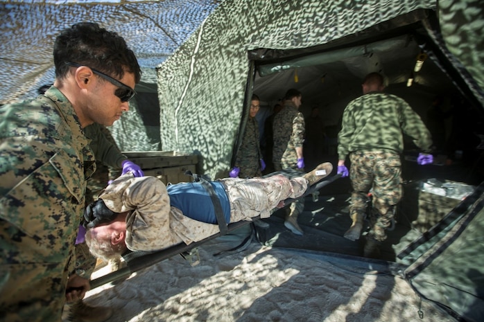 U.S. Marines and Sailors with 1st Medical Battalion, 1st Marine Logistics Group, transport a simulated casualty as a part of a tactical recovery aircraft personnel mission in support of Steel Knight 2016 at Marine Corps Air-Ground Combat Center, Twentynine Palms, Calif., Dec. 12, 2015. Steel Knight is an annual field training exercise that enables 1st Marine Division to test and refine its command and control capabilities by acting as the headquarters element for a forward-deployed Marine Expeditionary Force. (U.S. Marine Corps Combat Camera photograph by ( Lance Cpl. Roderick L. Jacquote)/RELEASED)