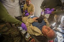 U.S. Navy Corpsmen with 1st Medical Battalion, 1st Marine Logistics Group, aid a simulated casualty as a part of a tactical recovery aircraft personnel mission in support of Steel Knight 2016 at Marine Corps Air-Ground Combat Center, Twentynine Palms, Calif., Dec. 12, 2015. Steel Knight is an annual field training exercise that enables 1st Marine Division to test and refine its command and control capabilities by acting as the headquarters element for a forward-deployed Marine Expeditionary Force. (U.S. Marine Corps Combat Camera photograph by ( Lance Cpl. Roderick L. Jacquote)/RELEASED)