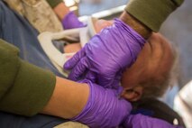 U.S. Navy Corpsmen with 1st Medical Battalion, 1st Marine Logistics Group, apply a neck brace onto a simulated casualty as a part of a tactical recovery aircraft personnel mission in support of Steel Knight 2016 at Marine Corps Air Ground Combat Center, Twentynine Palms, Calif., Dec. 12, 2015. Steel Knight is an annual field training exercise that enables 1st Marine Division to test and refine its command and control capabilities by acting as the headquarters element for a forward-deployed Marine Expeditionary Force. (U.S. Marine Corps Combat Camera photograph by ( Lance Cpl. Roderick L. Jacquote)/RELEASED)