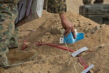 U.S. Marine Corps Maj. Justin Sharpe 1st Battalion, 1st Marine Regiment operations officer, places a reference card on the terrain model during a rehearsal of concept drill as a part of Steel Knight 16 at Marine Corps Air-Ground Combat Center, Twentynine Palms, Calif., Dec. 9, 2015. Steel Knight is an annual field training exercise that enables 1st Marine Division to test and refine its command and control capabilities by acting as the headquarters element for a forward-deployed Marine Expeditionary Force. (U.S. Marine Corps Combat Camera photograph by ( Lance Cpl. Roderick L. Jacquote)/RELEASED)