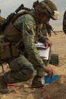 U.S. Marine Corps Maj. Justin Sharpe, 1st Battalion,1st Marine Regiment operations officer, places a reference card on a terrain model during a rehearsal of concept drill as a part of Steel Knight 2016 at Marine Corps Air-Ground Combat Center, Twentynine Palms, Calif., Dec. 9, 2015. Steel Knight is an annual field training exercise that enables 1st Marine Division to test and refine its command and control capabilities by acting as the headquarters element for a forward-deployed Marine Expeditionary Force. (U.S. Marine Corps Combat Camera photograph by ( Lance Cpl. Roderick L. Jacquote)/RELEASED)