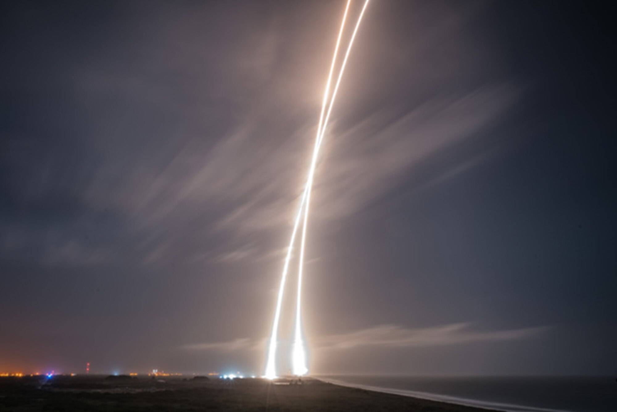 The twin streaks of light represent a time lapse photo showing both the launch and landing of a SpaceX Falcon 9 rocket, which completed the round trip from Earth to space (where the rocket placed 11 satellites in orbit) and back in roughly 10 minutes. The Falcon blasted off from Launch Complex 40 at nearby Cape Canaveral Air Force Station, then executed a perfect vertical landing and the former Launch Complex 13 -- now Landing Zone 1 -- a little more than five miles south from where it took off. It marked the first time a rocket delivered spacecraft into orbit and returned safely to Earth. SpaceX hopes to reuse their rockets, greatly reducing the cost of their space program. The reservists of the 920th Rescue Wing provide range clearance and safety contingency support for all rocket launches from CCAFS/Kennedy Space Center. (courtesy photo/SpaceX)