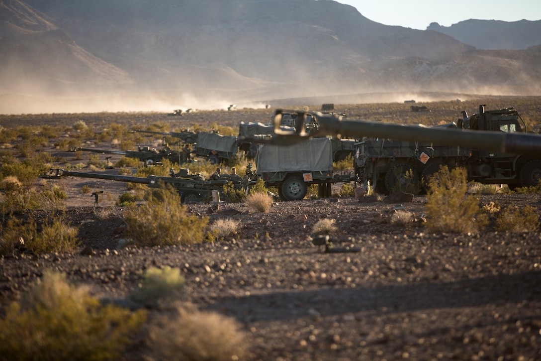 U.S. Marines with Mike Battery, 3rd Battalion, 11th Marine Regiment, 1st Marine Division, set up a gun line at a firing position during Steel Knight 2016 (SK-16) at Marine Corps Air Ground Combat Center Twentynine Palms, Calif., Dec 11, 2015. SK-16 is an annual military exercise developed to prepare 1st Marine Division personnel within the Ground Combat Element of a Marine Air-Ground Task Force. (U.S. Marine Corps photo by Lance Cpl Ryan Kierkegaard 1st Marine Division Combat Camera /Released)
