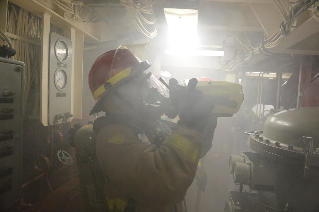 A U.S. sailor uses a K-90 Talisman XL thermal imager in a smoke filled compartment while participating in a fire drill aboard the USS Ross in the Black Sea, Dec. 10, 2015. U.S. Navy photo by Petty Officer 2nd Class Justin Stumberg