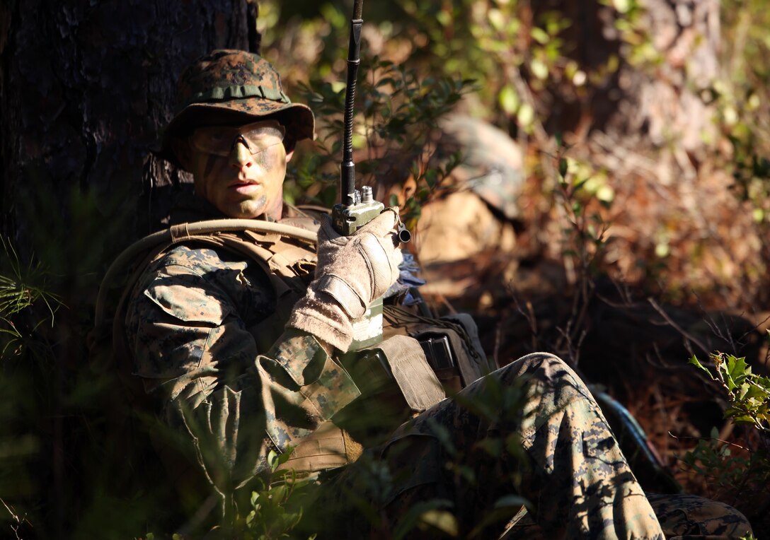 Lance Cpl. Silas Lewis, a rifleman with 2nd Light Armored Reconnaissance Battalion communicates grid coordinates during a patrolling exercise at Marine Corps Base Camp Lejeune, North Carolina, Dec 15, 2015. The unit practiced patrolling techniques and set up patrol bases to maintain readiness.