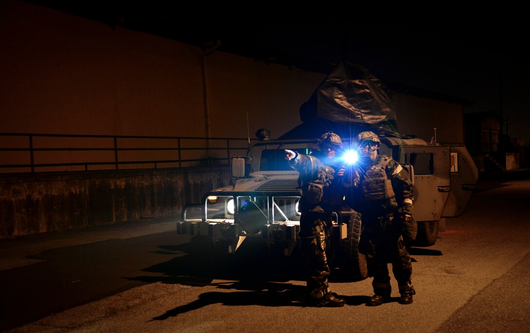 Airmen from the 51st Civil Engineer Squadron explosive ordnance disposal flight discuss the location of simulated unexploded ordnance during a training scenario at Osan Air Base, Republic of Korea, Nov. 6, 2015. EOD training usually consists of deployed IED scenarios, mine detection and electronic countermeasures to ensure their fight tonight readiness. (U.S. Air Force photo/Tech. Sgt. Travis Edwards)