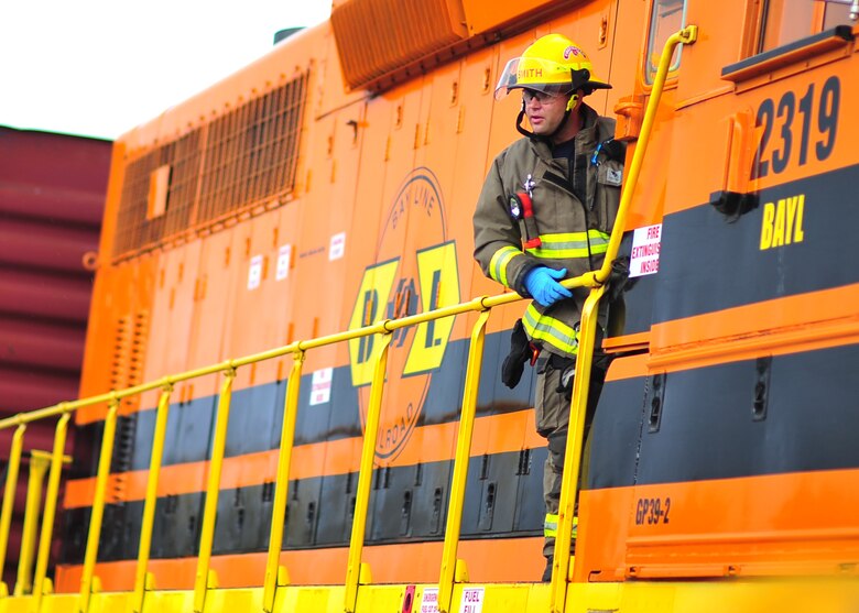 A Panama City Fire Department firefighter requests help for injured people in the locomotive of a train Dec. 17 at the Panama City Bay Line Railroad. This exercise helped strengthen the working relationship between Tyndall and local community agencies. (U.S. Air Force photo by Senior Airman Dustin Mullen/Released)