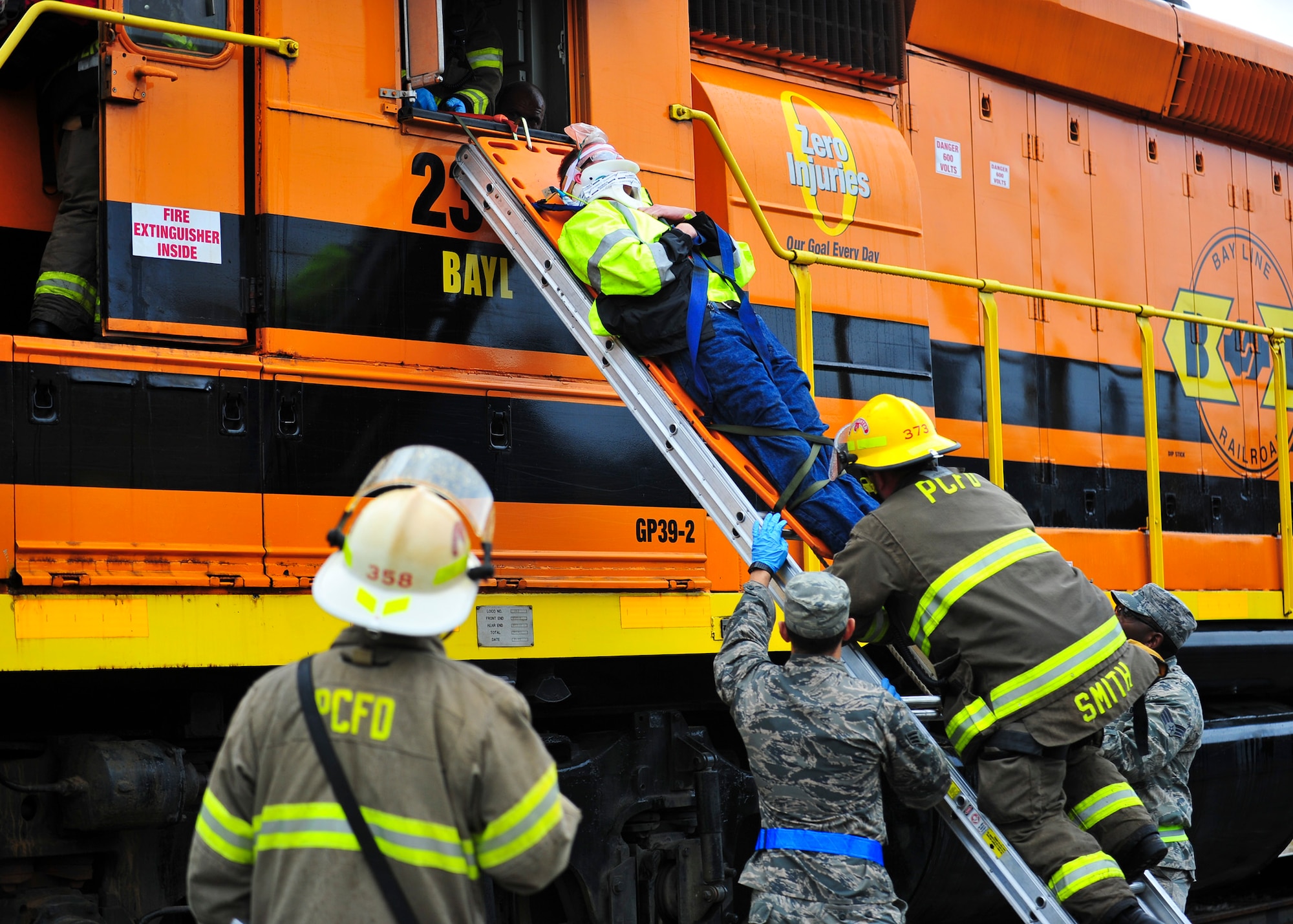An injured person is removed from a locomotive during a training exercise Dec. 17 at the Panama City Bay Line Railroad. During this exercise, Tyndall Airmen were embedded into their civilian counterpart’s units to work hand-in-hand and promote lateral learning on how they would both handle the incidents. (U.S. Air Force photo by Senior Airman Dustin Mullen/Released) 