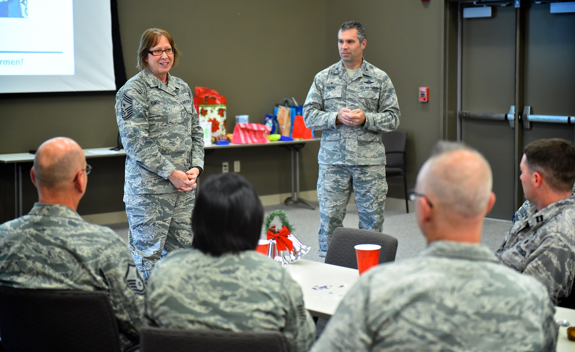 The 932nd Airlift Wing commander, Col. Karl Goerke, and command chief, Chief Master Sgt. Vicky Kuntz speak with the 932nd AW wing staff during a holiday potluck and commander's call Dec. 6, 2015,  at Scott Air Force Base, Illinois. Goerke  and Kuntz took time during the December unit training assembly to visit various holiday parties and wish everyone a safe and happy holiday season.  (U.S. Air Force photo by Tech. Sgt. Christopher Parr)