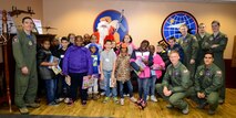 “Bandits” of the 349th Air Refueling Squadron pose with children from the Big Brothers Big Sisters of Wichita, Dec. 18, 2015, at McConnell Air Force Base, Kan. The 349th Air Refueling Squadron gave a tour of McConnell to 18 children and also handed out Christmas presents. (U.S. Air Force photo/Airman 1st Class Christopher Thornbury) 