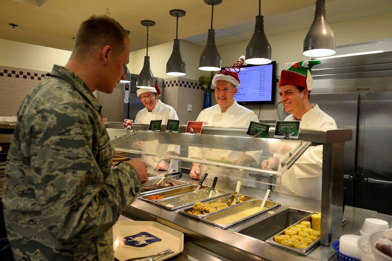 Senior leaders serve the holiday meal to Airmen Wednesday, Dec. 16, 2015, at Schriever Air Force Base, Colorado. The event was an opportunity for leadership to show their appreciation to Schriever Airmen as well as wish them happy holidays. (U.S. Air Force photo/Christopher DeWitt)