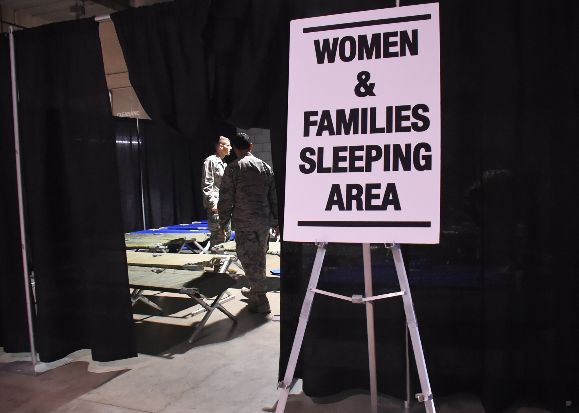 A couple of volunteers from the Space and Missile Systems Center at Los Angeles Air Force Base in El Segundo, Calif. finish setting up portable cots intended for the Women and Families sleeping area inside the Los Angeles Convention Center Dec. 18, 2015. More than 65 volunteers from SMC joined dozens of service providers from federal, state, city and county governments as well as local nonprofit partners from across Los Angeles County and the South Bay area for the 2nd annual L.A. Vets Stand Down, billed as the largest three-day event for homeless military veterans and their families to ever take place in the country. (U.S. Air Force photo/Sarah Corrice)