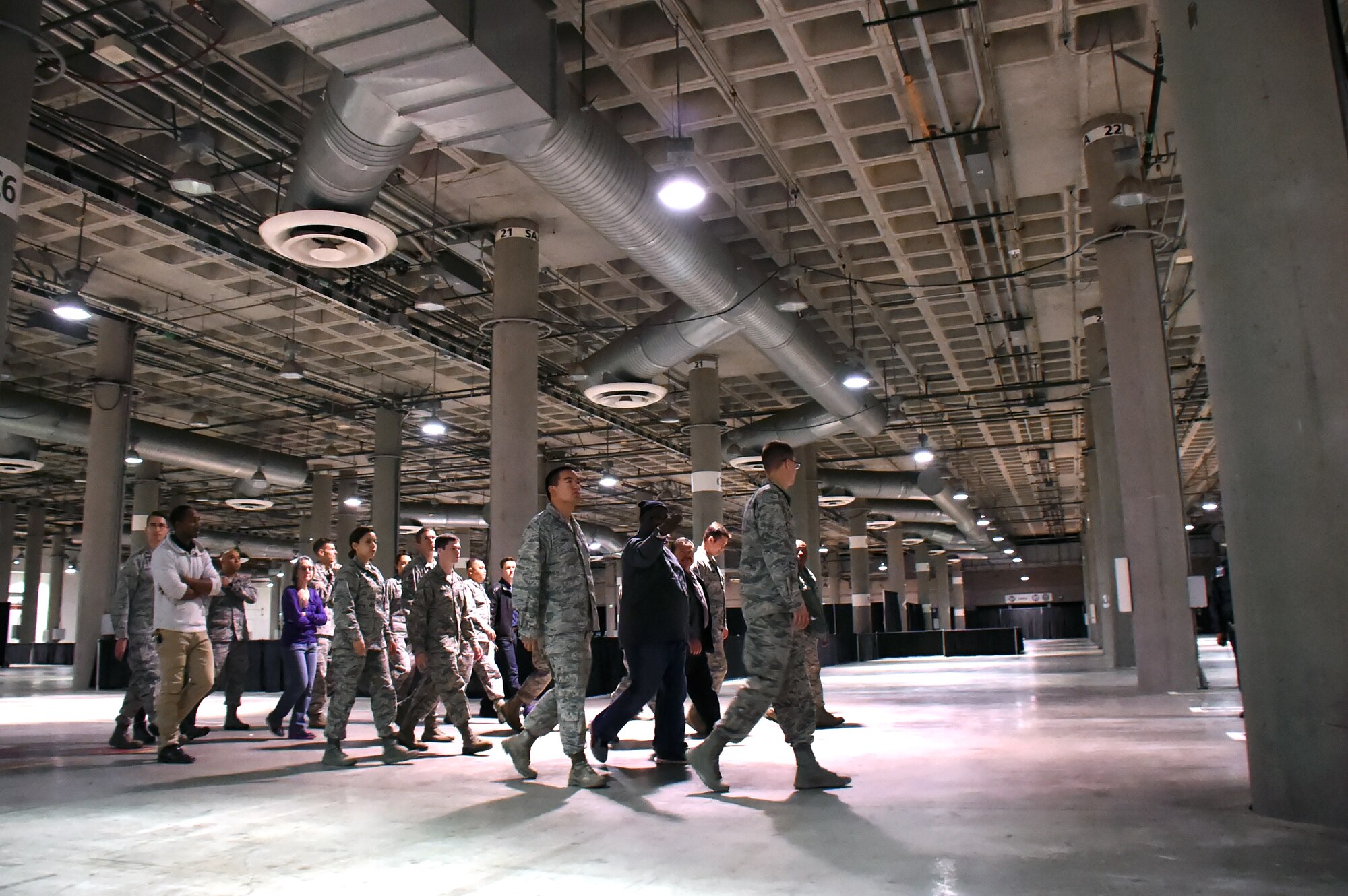 Ivan Mason, center, executive director of U.S. Vets Inglewood provides a walk-through familiarization tour of the Los Angeles Convention Center to a group of volunteers from the Space and Missile Systems Center prior to setting up for the 2nd annual L.A. Vets Stand Down Dec. 18, 2015. United States Veterans Initiatives, a private non-profit organization, is one of many private and public services who came together with SMC personnel during the three-day event to provide housing, employment, and counseling services to homeless veterans living on the streets or shelters in Los Angeles. (U.S. Air Force photo/Sarah Corrice)