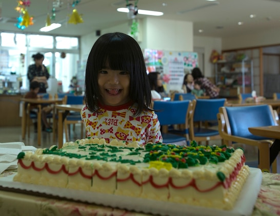 Satsuki Ashitomi eagerly waits for a piece of cake Dec. 19 at the Kin Town Social Welfare Center, Okinawa, Japan. Marines organized a toy drive through the Kin Town Single Parent Association to give back to their community by handing out gifts and cake to the children. The Marines are with 3rd Intelligence Battalion, III Marine Headquarters Group, III Marine Expeditionary Force. (U.S. Marine Corps photo by Cpl. Isaac Ibarra/Released)
