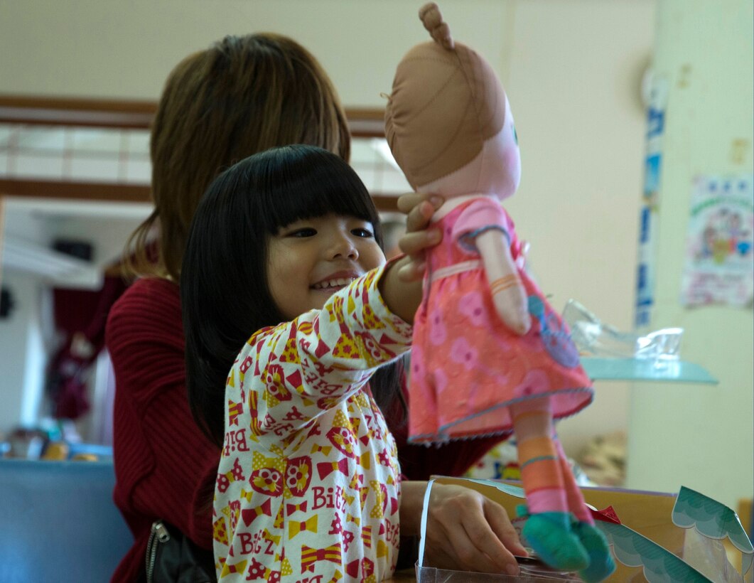 Satsuki Ashitomi plays with her new doll Dec. 19 at the Kin Town Social Welfare Center, Okinawa, Japan. Marines organized a toy drive through the Kin Town Single Parent Association to give back to their community by handing out gifts and cake to the children. The Marines are with 3rd Intelligence Battalion, III Marine Headquarters Group, III Marine Expeditionary Force. (U.S. Marine Corps photo by Cpl. Isaac Ibarra/Released)