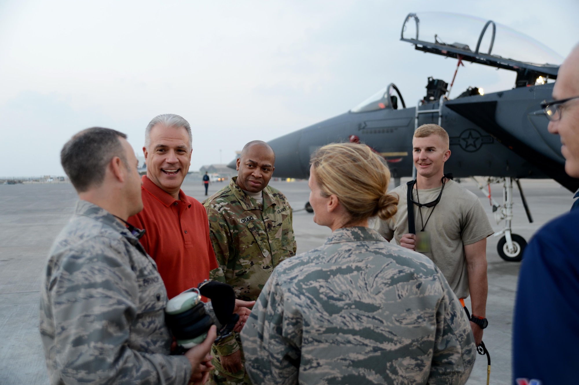 Ken Caldwell, senior vice president and general sales manager for theatrical sales and distribution, North America, Walt Disney Studios Motion Pictures, visits with Airmen from the 380th Air Expeditionary Wing in front of an F-15E Strike Eagle at an undisclosed location, Dec. 21, 2015. Caldwell personally thanked and coined several maintainers, thanking them for their service in support of Operation Inherent Resolve. (U. S. Air Force photo by Tech. Sgt. Frank Miller/Released)