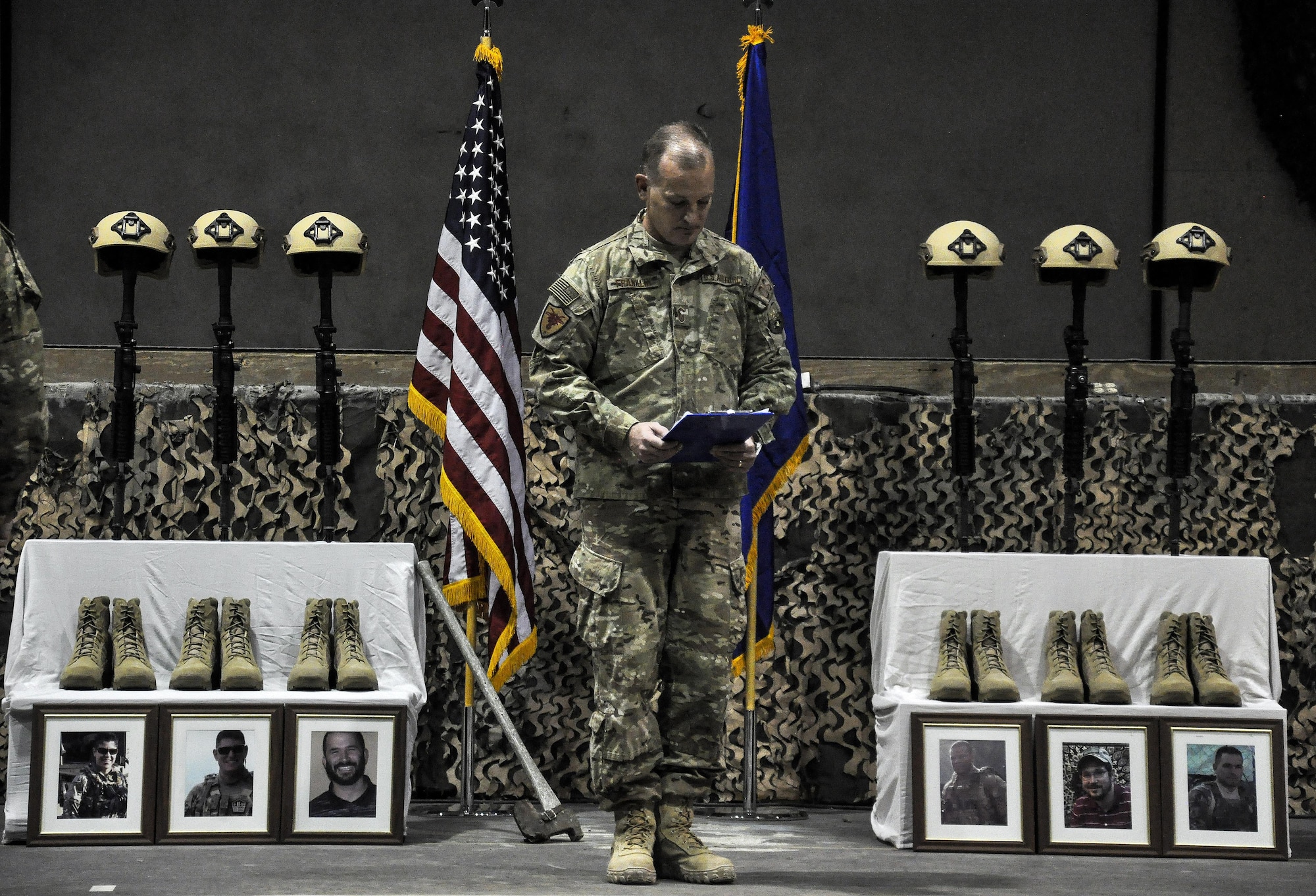 Service members from several units at Bagram Airfield, Afghanistan pay their respects during a fallen comrade ceremony held in honor of six Airmen Dec. 23, 2015.  The six Airmen lost their lives in an improvised explosive attack near Bagram Dec. 21, 2015. (U.S. Air Force photo by Tech. Sgt. Nicholas Rau)