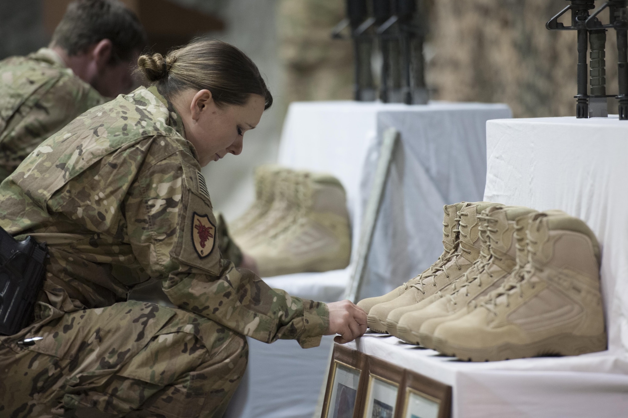Service members from several units at Bagram Airfield, Afghanistan pay their respects during a fallen comrade ceremony held in honor of six Airmen Dec. 23, 2015.  The six Airmen lost their lives in an improvised explosive attack near Bagram Dec. 21, 2015. (U.S. Air Force photo by Tech. Sgt. Robert Cloys)