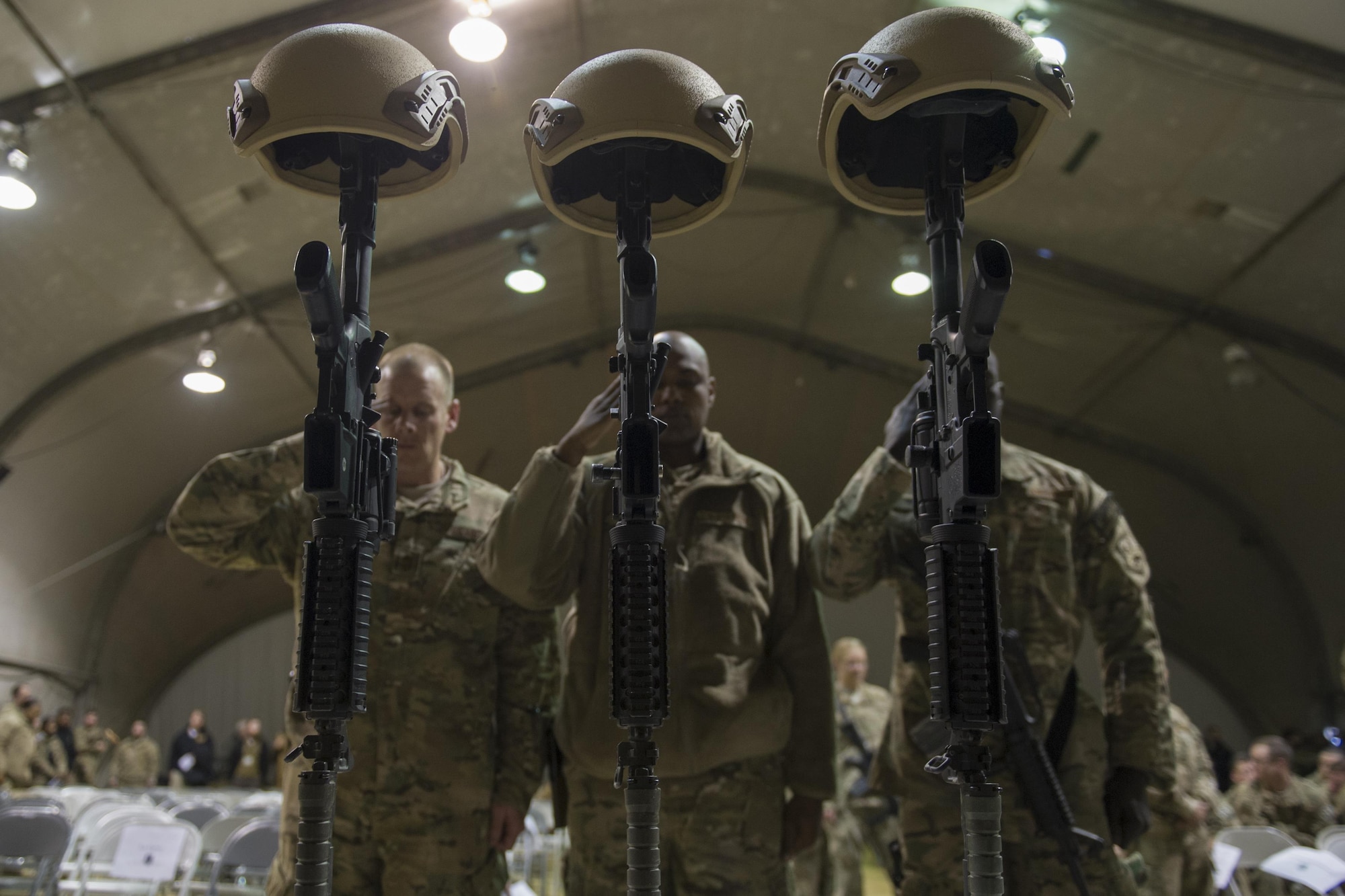 Service members from several units at Bagram Airfield, Afghanistan pay their respects during a fallen comrade ceremony held in honor of six Airmen Dec. 23, 2015.  The six Airmen lost their lives in an improvised explosive attack near Bagram Dec. 21, 2015. (U.S. Air Force photo by Tech. Sgt. Robert Cloys)