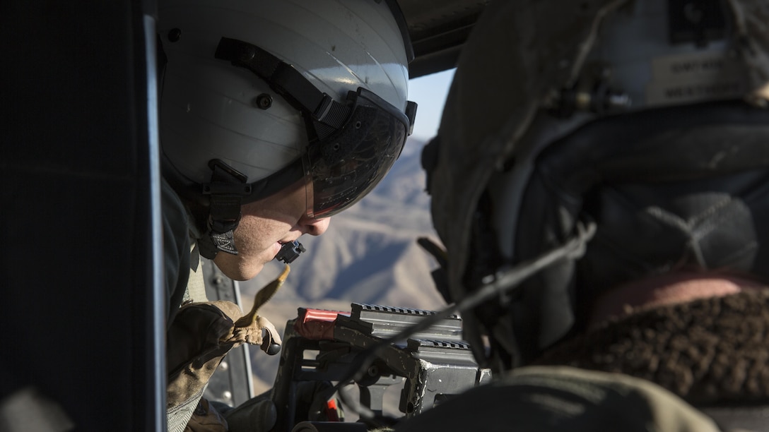 Lance Cpl. Daniel Rios, a crew chief student with Marine Light Attack Helicopter Training Squadron 303, fires a .50 caliber machine gun during an aerial gunnery shoot at Marine Corps Base Camp Pendleton, California, Dec. 17. Marines with HMLAT-303 flew a formation flight and conducted an aerial gunnery to shoot give students the opportunity to refine basic skills needed to operate in the Fleet Marine Force.