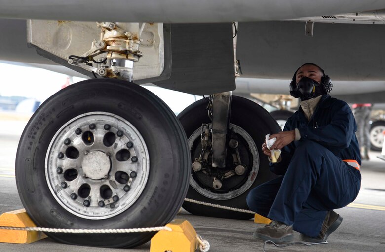 U.S. Air Force Airman 1st Class Adyel Quinones-Velez, a 18th Aircraft Maintenance Squadron crew chief, inspects the underside of an F-15 Eagle at Misawa Air Base, Japan, Dec. 15, 2015. Conducting an Aviation Training Relocation during winter provided Kadena AB, Japan, pilots and maintainers a change in environment. (U.S. Air Force photo/Airman 1st Class Jordyn Fetter)