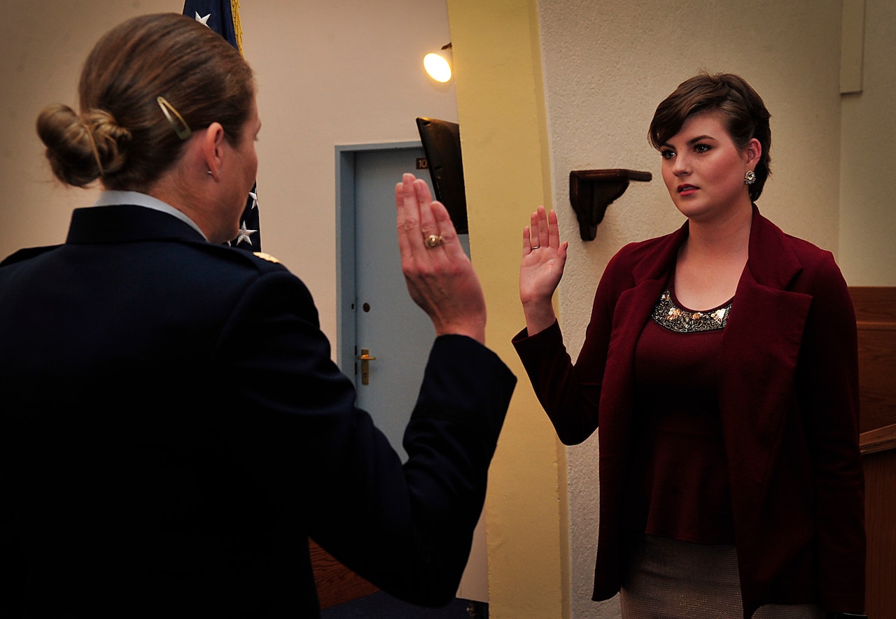 U.S. Air Force Maj. Brittany Nutt, a women's health nurse practitioner with the 86th Medical Squadron, swears her daughter, Kiersten, into the Air Force at Landstuhl Regional Medical Center, Germany, Nov. 23, 2015. U.S. Air Force photo by Airman 1st Class Larissa Greatwood