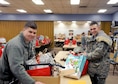 Senior Airman Logan Stack, from Detachment 2, 56th Operations Group, and Staff Sgt. Tylor Strop, assigned to the 173rd Fighter Wing, pick up Christmas gifts from the Arthur Street Senior Center to deliver to Meals on Wheels clients Dec. 16, 2015, at Klamath Falls, Ore. The 173rd FW has partnered with the Arthur Street Senior Center for over 15 years to distribute the holiday gifts collected by the center. (U.S. Air National Guard photo/Staff Sgt. Penny Snoozy) 
