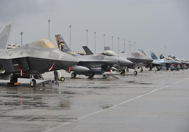 An F-22 Raptor and a T-38 Talon from Tyndall Air Force Base, Fla., F-16 Fighting Falcons from Shaw AFB, S.C. and Eielson AFB, Alaska, and an F-35 Lightning II from Eglin AFB, Fla., sit on the flightline at Tyndall AFB Dec. 17, 2015, during exercise Checkered Flag 16-1. Checkered Flag 16-1 is a large force exercise that simulates employment of a large number of aircraft from a simulated deployed environment. (U.S. Air Force photo/Senior Airman Sergio A. Gamboa) 
