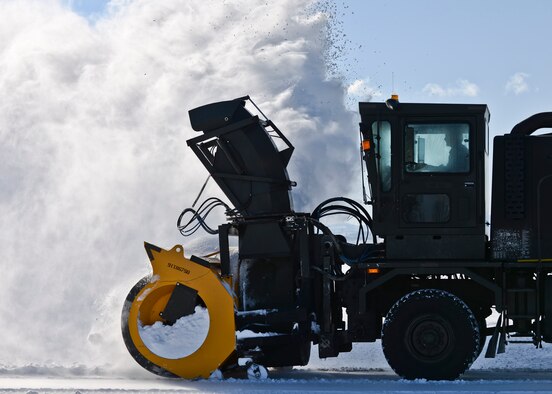 A member of the 28th Civil Engineer Squadron operates a snow blower to clear the flightline at Ellsworth Air Force Base, S.D., Dec. 16, 2015. The airfield is the 28th CES’s biggest mission and number one priority during winter months. (U.S. Air Force photo/Airman Sadie Colbert) 
