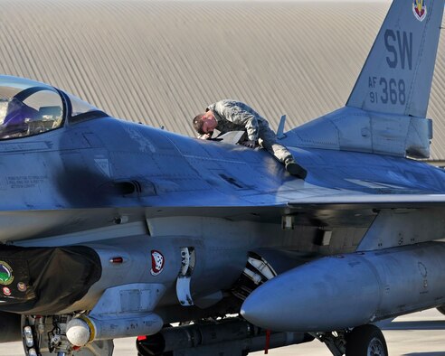 A 77th Aircraft Maintenance Unit dedicated crew chief from Shaw Air Force Base, S.C. performs maintenance on an F-16 Fighting Falcon Dec. 15, 2015, on the flightline at Tyndall AFB, Fla. The F-16 is a compact, multi-role fighter aircraft. It is highly maneuverable and has proven itself in air-to-air combat and air-to- surface attack. (U.S. Air Force photo/Senior Airman Sergio A. Gamboa) 
