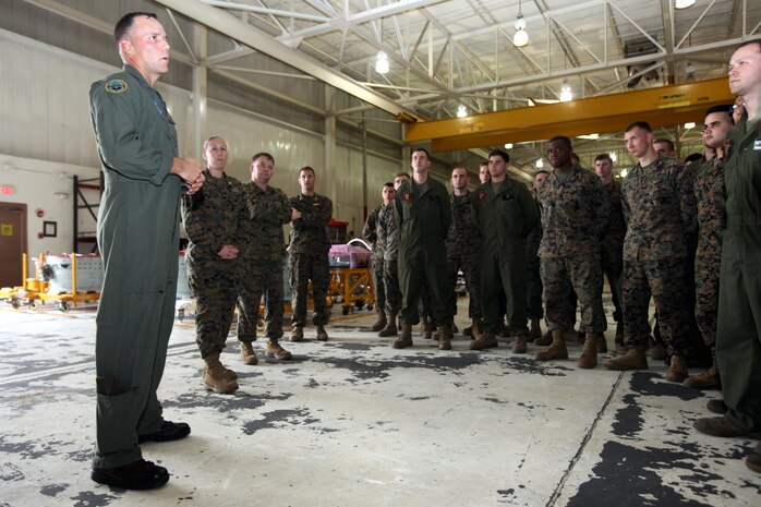 Col. Eric E. Austin congratulates Marine Aviation Logistics Squadron 14 Marines for reaching the Deputy Commandant of Aviation's goal of 155 available Harrier engines at Marine Corps Air Station Cherry Point, N.C., Dec. 18, 2015. That number was determined by considering the number of Harriers still in the fleet along with the number of spares that are required around the world to keep the Harrier community in the air. Austin is the commanding officer for Marine Aircraft Group 14. (U.S. Marine Corps photo by Cpl. Jason Jimenez/Released)