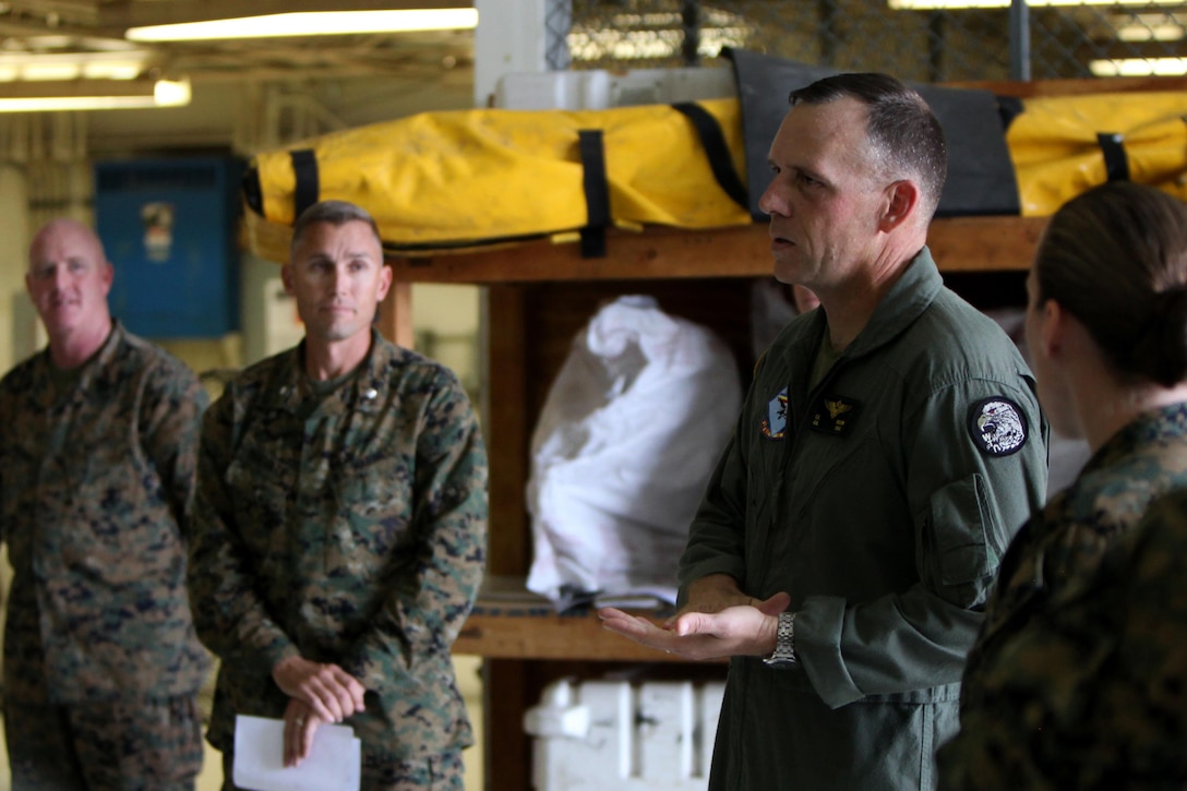 Col. Eric E. Austin congratulates Marine Aviation Logistics Squadron 14 Marines for reaching the Deputy Commandant of Aviation's goal of 155 available Harrier engines at Marine Corps Air Station Cherry Point, N.C., Dec. 18, 2015. That number was determined by considering the number of Harriers still in the fleet along with the number of spares that are required around the world to keep the Harrier community in the air. Austin is the commanding officer for Marine Aircraft Group 14. (U.S. Marine Corps photo by Cpl. Jason Jimenez/Released)