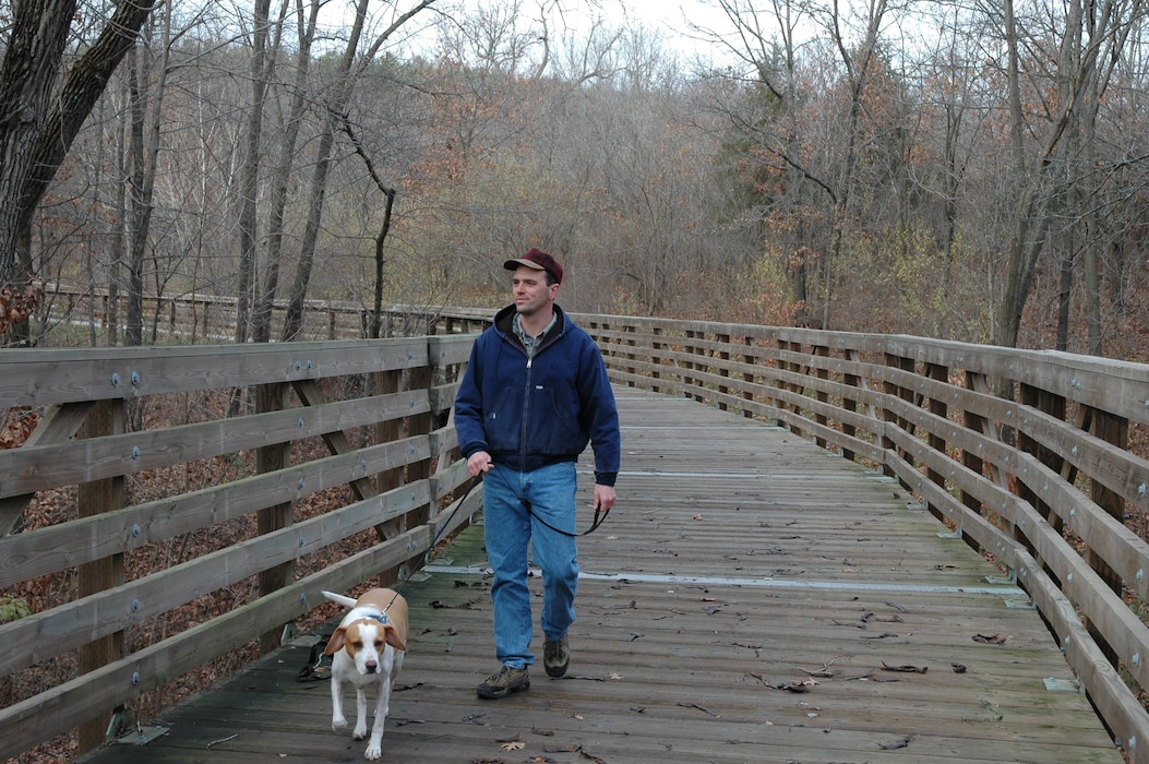 Man walking dog on Volksweg Trail