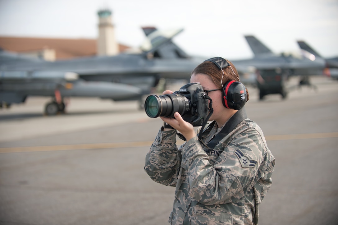 U.S. Air Force Airman 1st Class Cassandra Whitman, a 354th Fighter Wing public affairs photojournalist, takes photos Aug. 4, 2015, during RED FLAG-Alaska 15-3, at Eielson Air Force Base, Alaska. Whitman is approaching the one year mark in the Air Force and reflected on how her decision to join the military has positively affected her life. (U.S. Air Force photo by Staff Sgt. Shawn Nickel/Released)